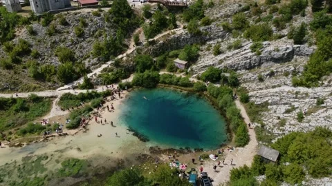Drone view on very deep river spring in the mountains. Church near water spring Video stock 231392794