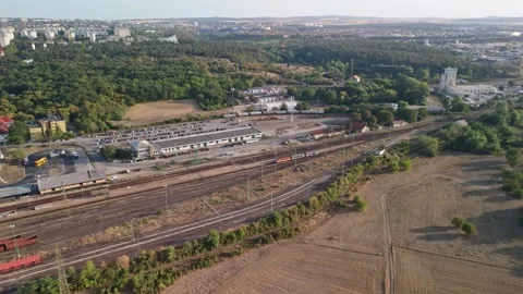 Drone view of Veszprém rail yard with trains and urban warehouses near homes Stock Footage 346224329