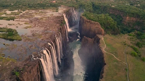 Drone view Waterfall, Vista Displaying Stone Structures Amidst Energetic Water Vídeo Stock 338361077