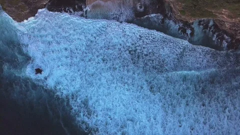 Drone view on waves and rock side at the beach Stockbeeldmateriaal 115901099