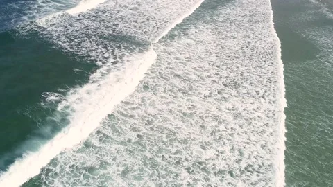 Drone view of waves arriving at the shore of a beach Stock Footage 277954782