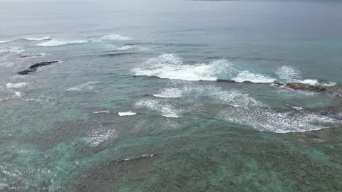 Drone view of waves breaking over turquoise reef and rocks in Hawaii Stock-Footage 348170955