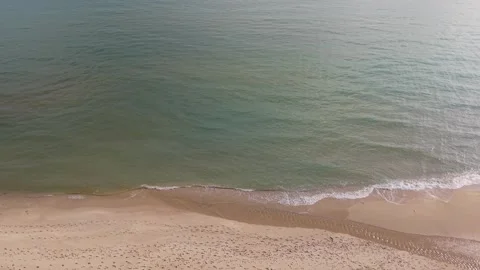 Drone view of waves hitting sandy beach in autumn calm Stock Footage 321047144