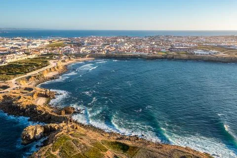 Drone view of waves in small bay by town of Peniche, Portugal Stock Photos