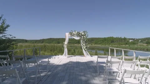 Drone view of wedding arch on the pier by the river next to the forest Stock Footage 157571487