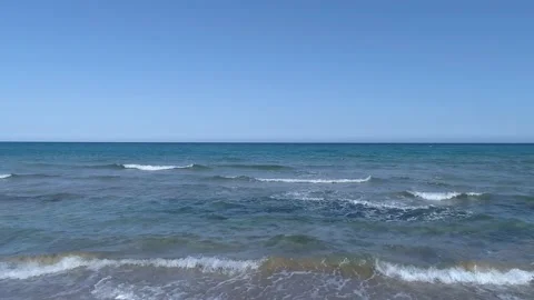 Drone view while sicilian sea waves breaking on sandy coastline, Noto, Sicily Stock Footage 179970709