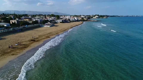 Drone view while sicilian sea waves breaking on sandy coastline, Noto, Sicily Stock Footage 179971011