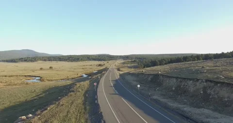 Drone view of a white car passing on the empty highway 库存影片 201595664
