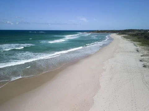 Drone view of white sandy beach with coastal forest Stock Photos