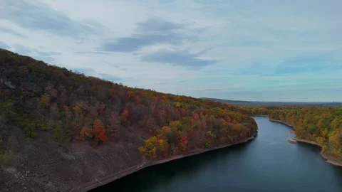 Drone view of a wide river winding through colorful autumn forest... Stock Footage 319884156