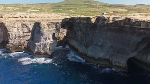 Drone view of Wied il-Mielaħ arch, Gozo cliffs and blue sea in Malta coast Stock Footage 341387174