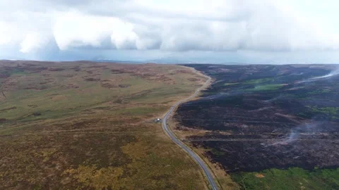 Drone View of Wildfire Damage and Smouldering Hillside Видео 345100327
