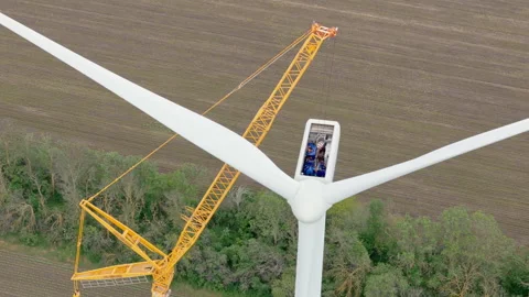 Drone view wind park construction with crane and turbine workers close up. Stock Footage 322509967