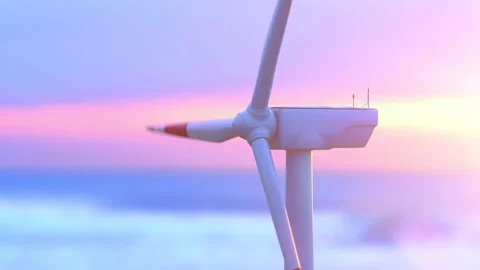 Drone view of wind turbine spinning against magenta sunrise Stock Footage