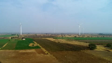 Drone View of Wind Turbines Across Agricultural Fields in Gujarat, India 01 Stock Footage 341387683