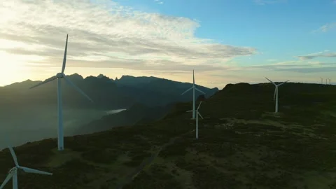 Drone view of Wind turbines in the mountains with amazing sunrise, foggy clouds Stock Footage 278720408