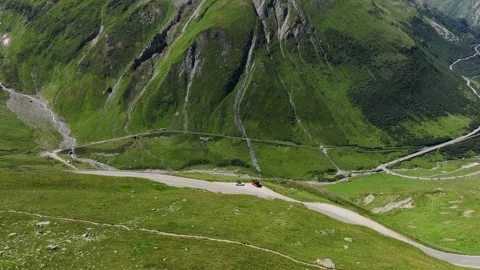 Drone View of Winding Furka Pass Road Cutting Through Swiss Alps Green Mountains Stock Footage 310212962