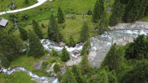 Drone View of a Winding Mountain River Flowing Through Lush Green Alps in S.. Stock Footage 342606413