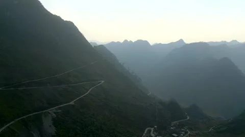 Drone view of winding mountain road in Ha Giang Vietnam with deep valley Video stock 313797601