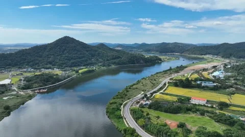 Drone view of a winding river cutting through green fields Stock Footage 313252986