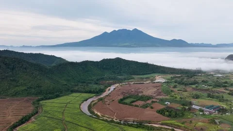 Drone view of a winding river flowing near rural agricultural lands Stock Footage 346012269