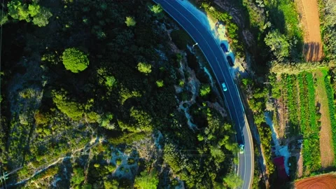 Drone view of a winding road in a mountainous area with moving cars on an asp Video stock 197376426