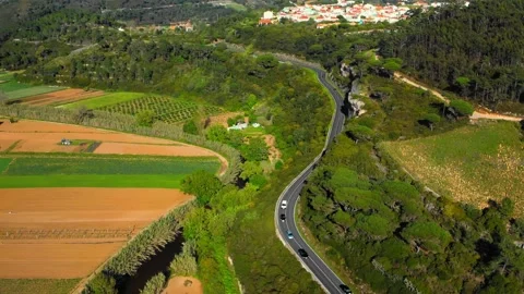 Drone view of a winding road in a mountainous area with moving cars on an a.. Stock Footage 265579372