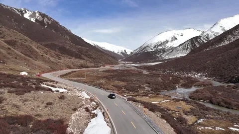Drone view of winding road through western China mountain valley Stock Footage 337894294