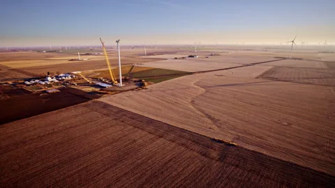 Drone view of windmill construction amid expansive Illinois farmland Stock Footage 328388134