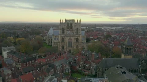 Drone view of York Minster Cathedral and surrounding buildings in York at sunset Video stock 296760502