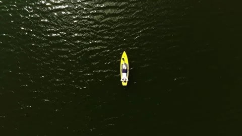 Drone view of a young guy paddling a SUP board Stock Footage 248283002