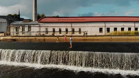 A drone view of a young guy standing on the dam in the Czech Republic Stock Footage 254917803