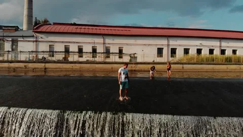 A drone view of a young guy standing on the dam in the Czech Republic Stock Footage 254918134