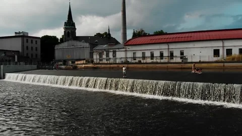 A drone view of a young guy standing on the dam in the Czech Republic Stock Footage 254918183