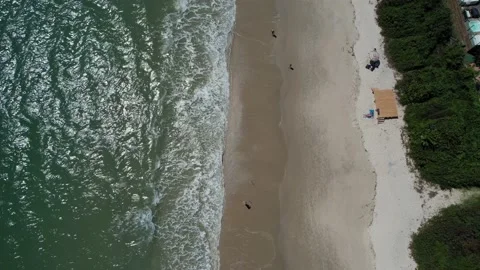 Drone walking along the sands of a beautiful beach with clear water Stock Footage 229853306