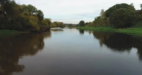 The drone was flying over the river before sunset Stock Footage 140669922