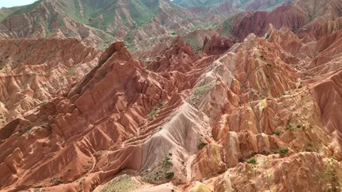 Drone weaving between towering red pinnacles and deep gullies in Skazka Canyon, Stock Footage 341870780