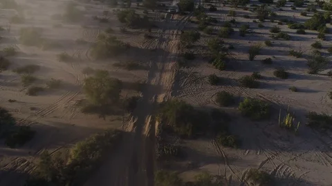 Drone wide tracking shot of Baja 1000 Trophy Truck racing Stock Footage 104883906