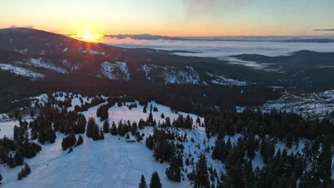 Drone winter orbit panorama of mountain sunrise over snow fields Stock Footage 336446115
