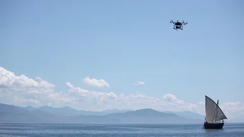 A drone working and flying over the sailboat 스톡 동영상 77585734
