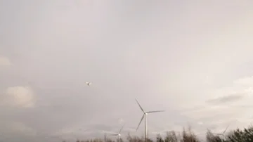 Drone working on Wind turbine farm renewable energy jobs  Stock Footage 85772572