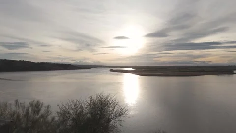 Drone yaw over Tagus river meander, cliffs and birdwatching hide in backlight Stock Footage 335175959