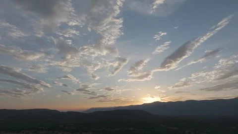 Drone yaw over Tietar valley at sunset with mountains silhouette and dramatic Видео 333022449