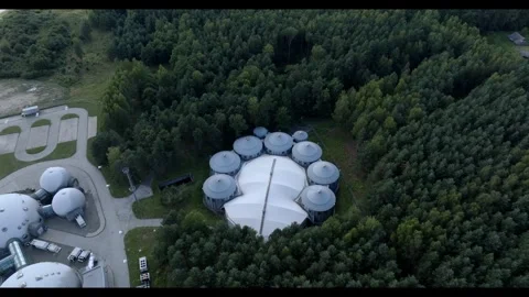 Drone zoom in to Complex of Round Metal Buildings with Conical Roofs Stock Footage 285540194