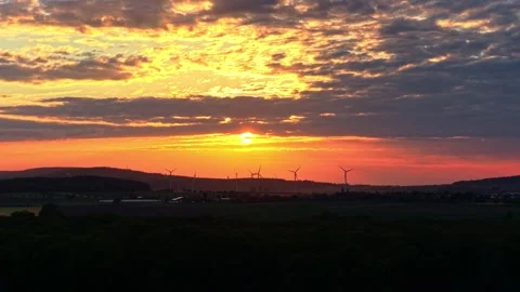 Drone Zoom In at Dramatic Sunset Over Wind Turbines Germany Stock Footage 336218446