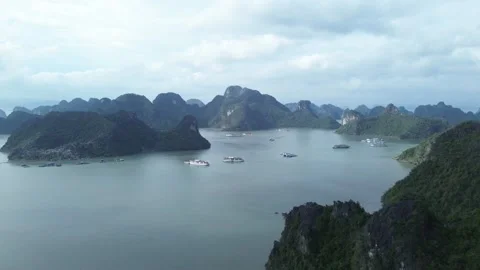 Drone zoom in over limestone islands and scattered cruise boats, Cat Ba Stock Footage 313610776