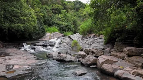 Drone Zoom-In  Shot of Small Waterfall in Tropical Forest Stock Footage 314666802