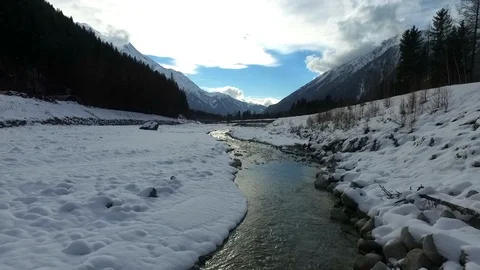 Droneflight over winterriver in Chamonix Stock Footage 108639773