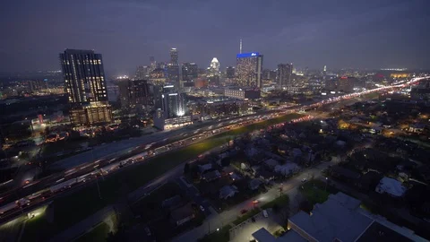 Dronelapse Hyperlapse flying towards City Skyline at dusk over traffic Stock Footage 102397844