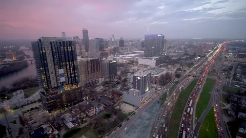 Dronelapse Hyperlapse following downtown traffic jam on highway at sunset Video stock 102397282